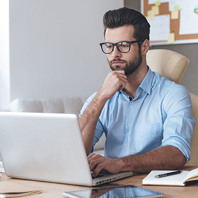 img of a man looking at a computer