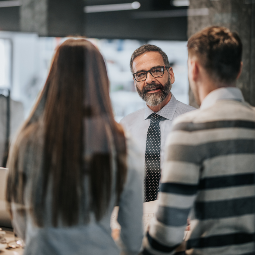 A tax professional speaking with two clients